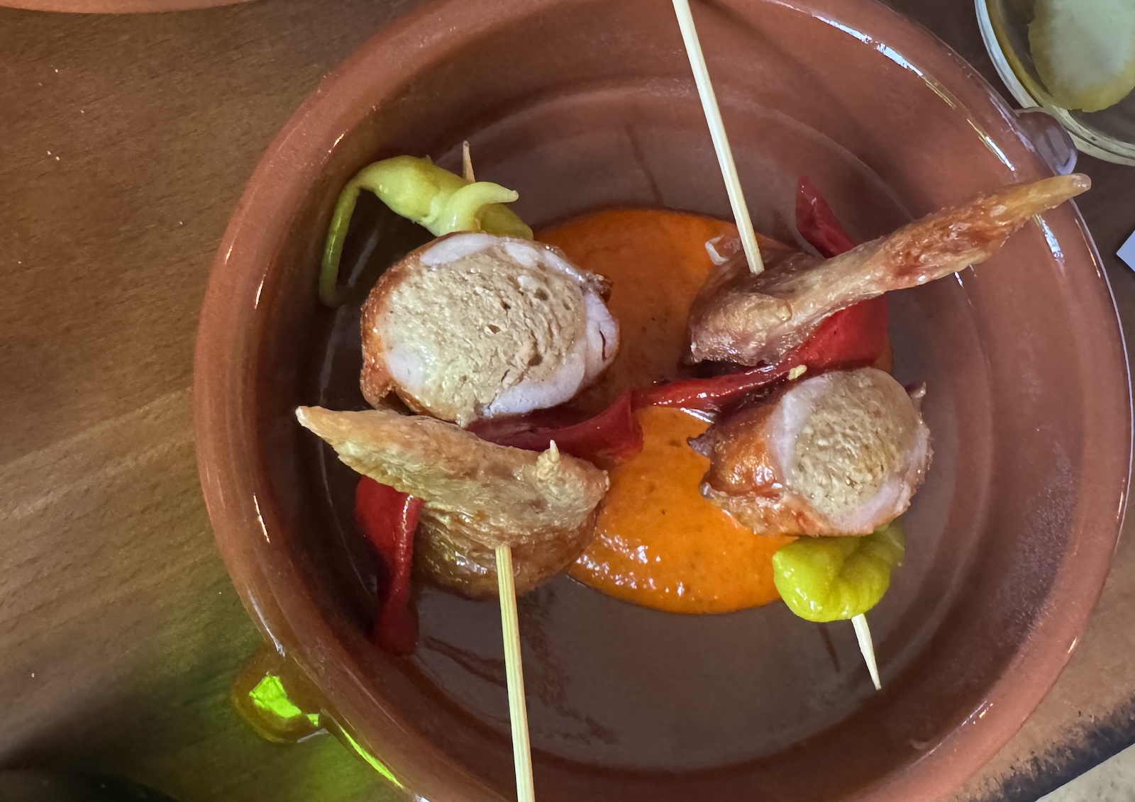 Chicken wings deboned and sfuffed with sausage on skewers.
