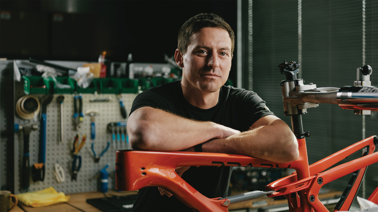 Adam Miller leaning on a Revel bike