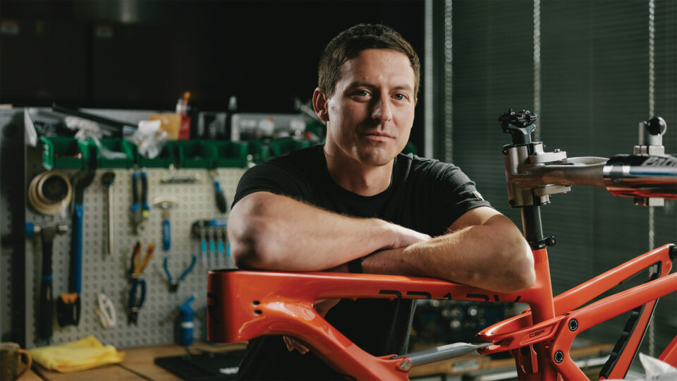 Adam Miller leaning on a Revel bike