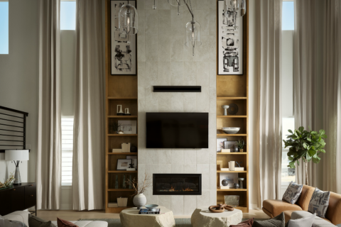 A living with room with high ceiling, a glass light fixture and wooden insert shelves