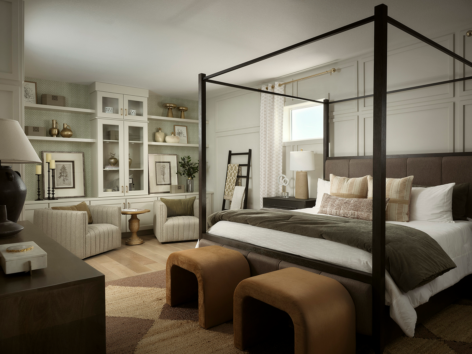 Primary bedroom with a four poster bed and a sitting area