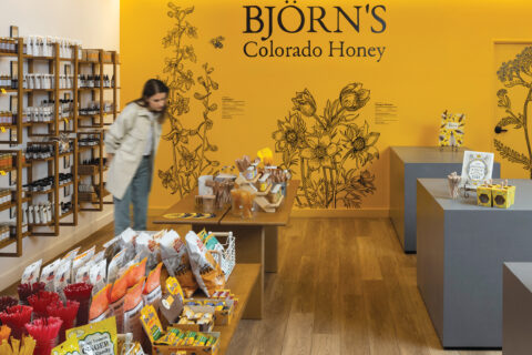 A woman inside Björn’s Colorado Honey cafe in DIA