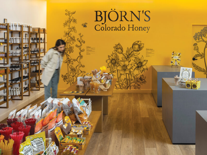 A woman inside Björn’s Colorado Honey cafe in DIA