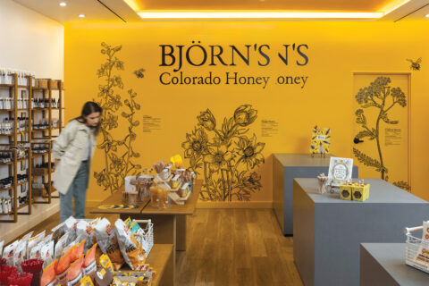 A woman inside Björn’s Colorado Honey cafe in DIA