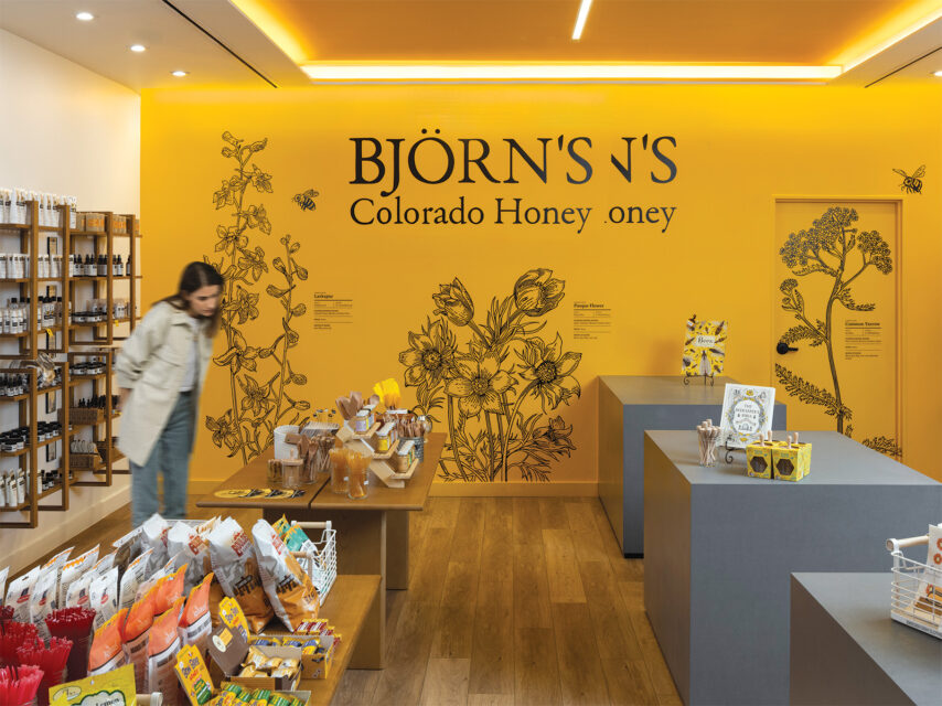 A woman inside Björn’s Colorado Honey cafe in DIA