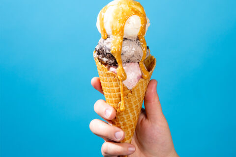Sesame caramel sauce on scoops of toasted sesame, cookies and cream, and roasted strawberry jam