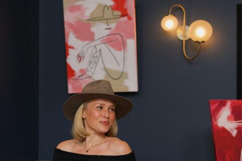 Ariana Barnstable with her paintings at Denver's Ramble Hotel, where she was 2026 winter artist-in-residence. Photo by Kelly Calvillo