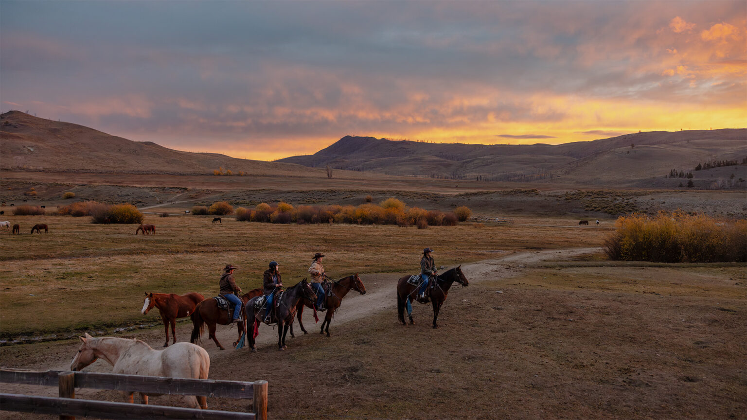 Four people riding horses at C Lazy U Ranch in Granby, Colorado