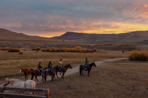 Four people riding horses at C Lazy U Ranch in Granby, Colorado