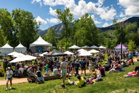 People mill around a festival in Boulder, Colorado