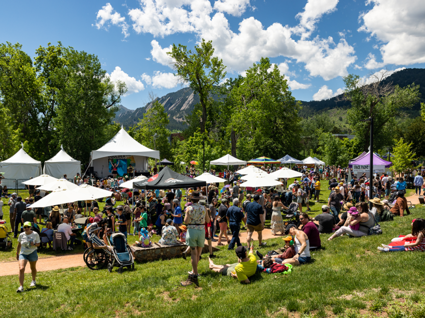People mill around a festival in Boulder, Colorado
