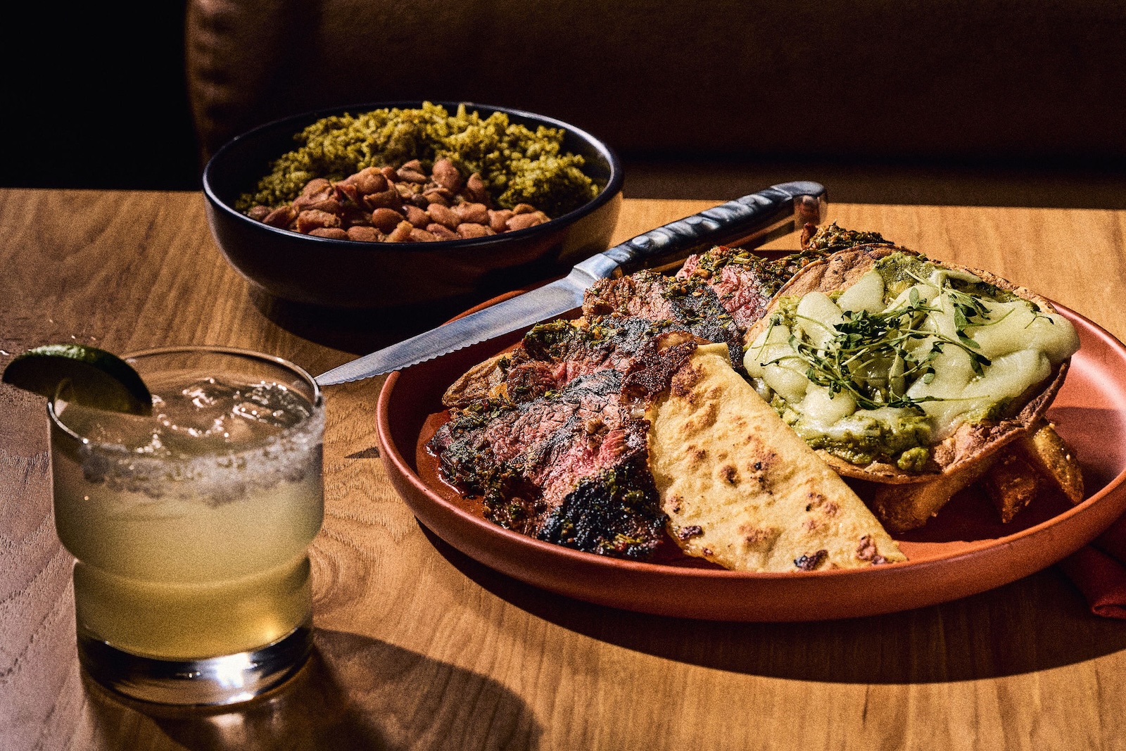 Steak with charro beans, rice, and other sides