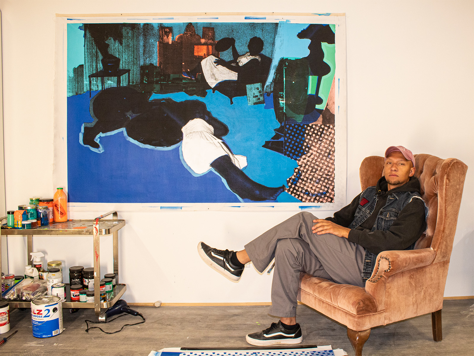 Kristopher Wright in front of his art