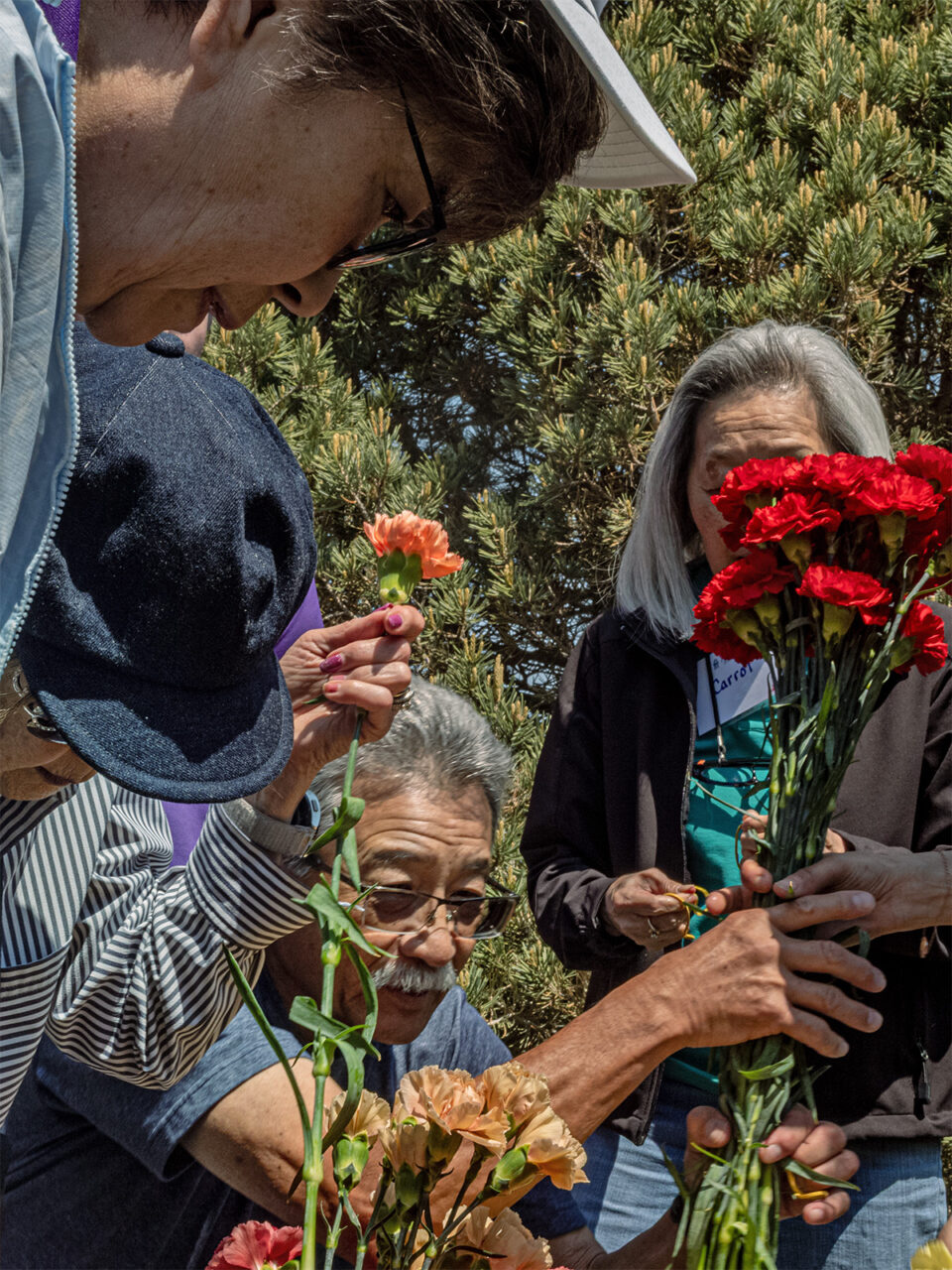 Family placing flowers at a memorial