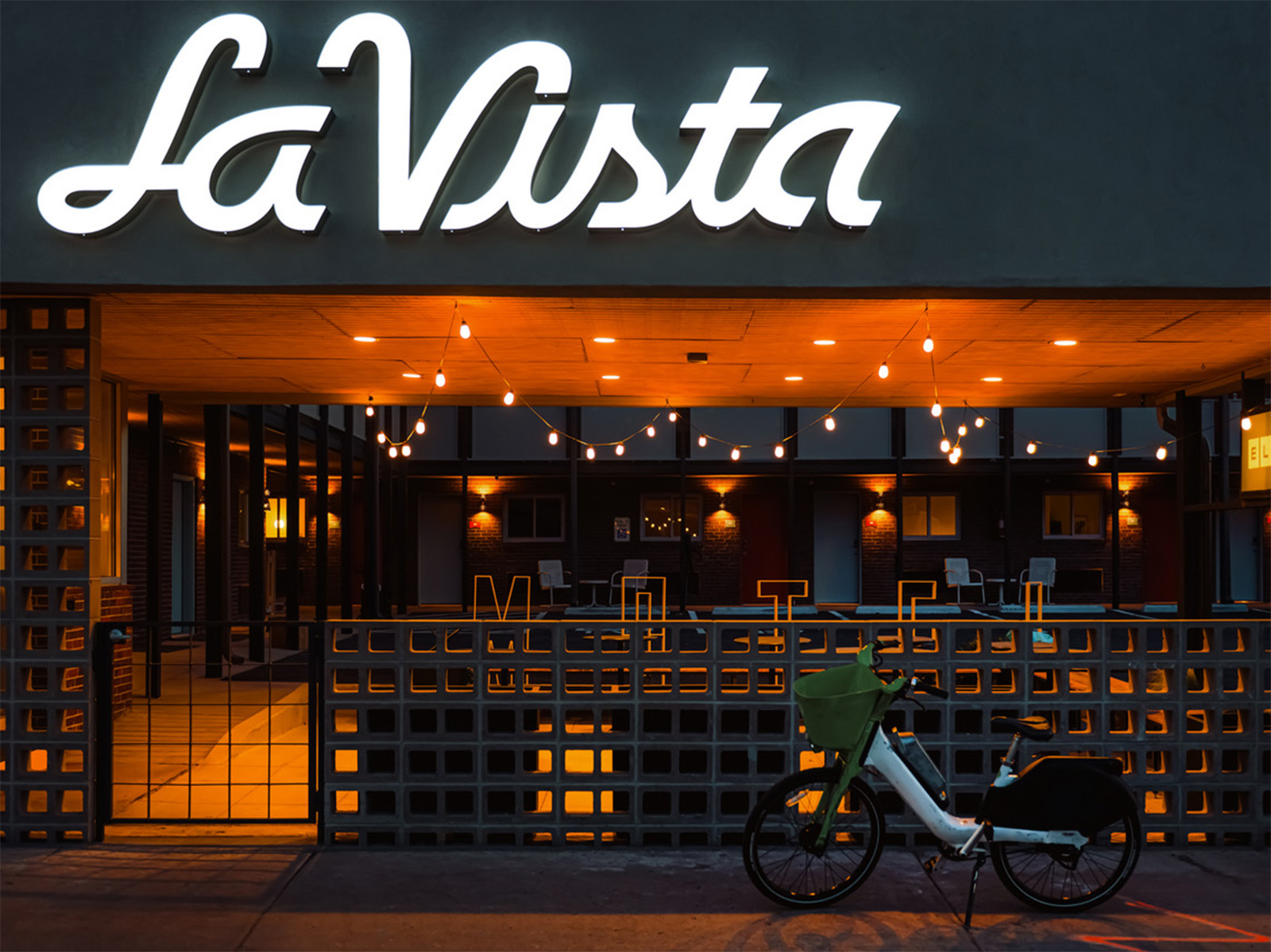 The facade of La Vista Motel with an e-bike out front