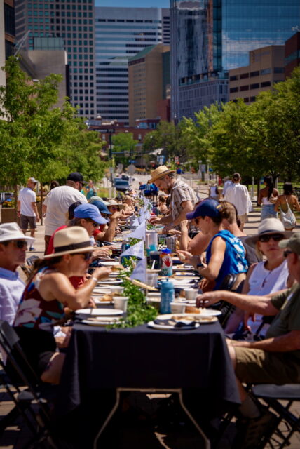 A crowd of people sitting at a long table.