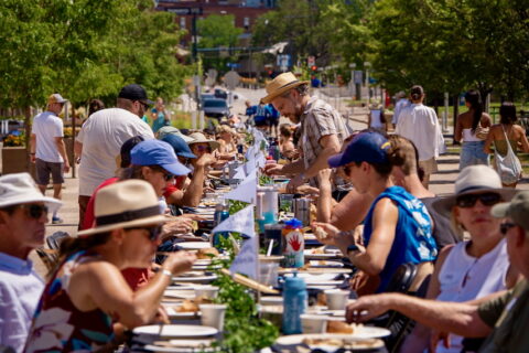 A crowd of people sitting at a long table.