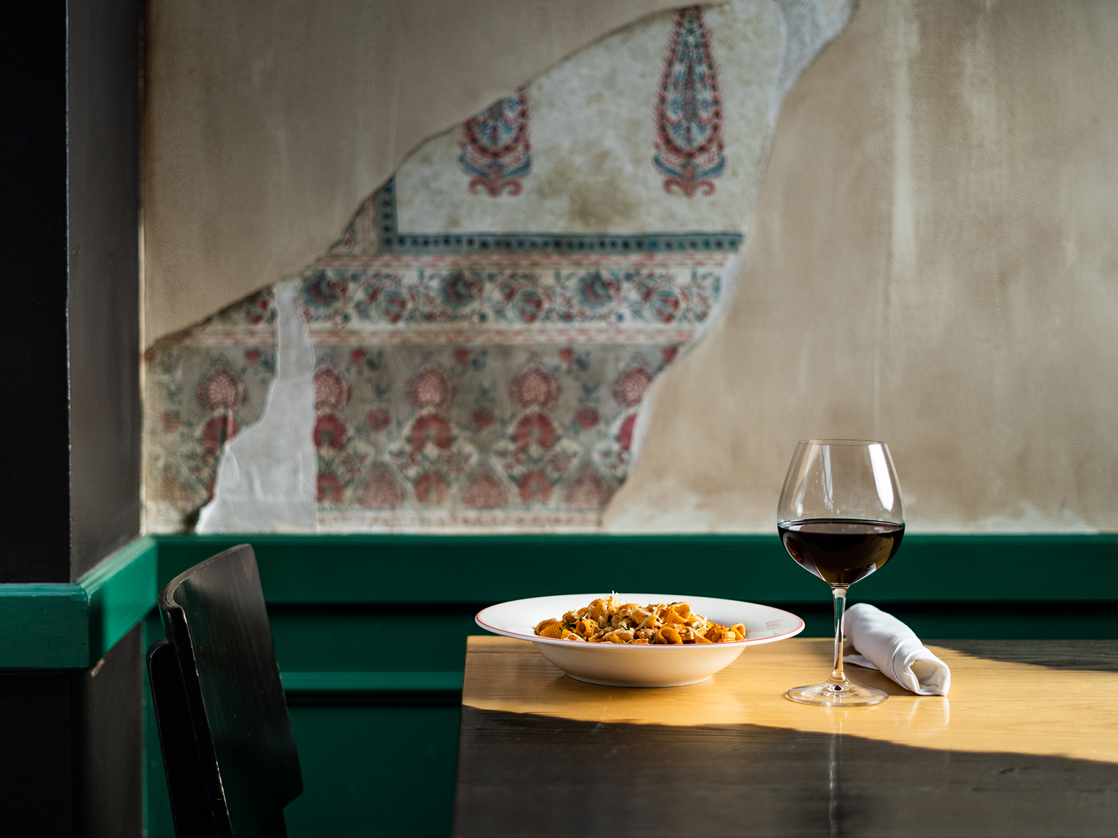 Plate of pasta and a glass of red wine