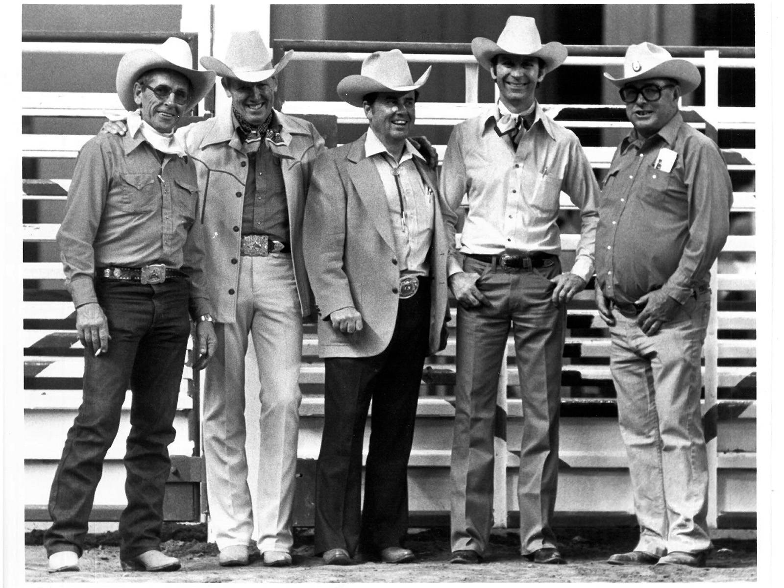 Five cowboys in an arena