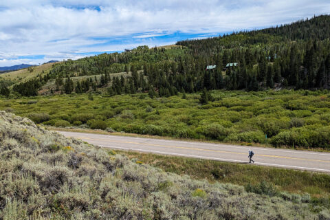 A hiker on a highway in Colorado