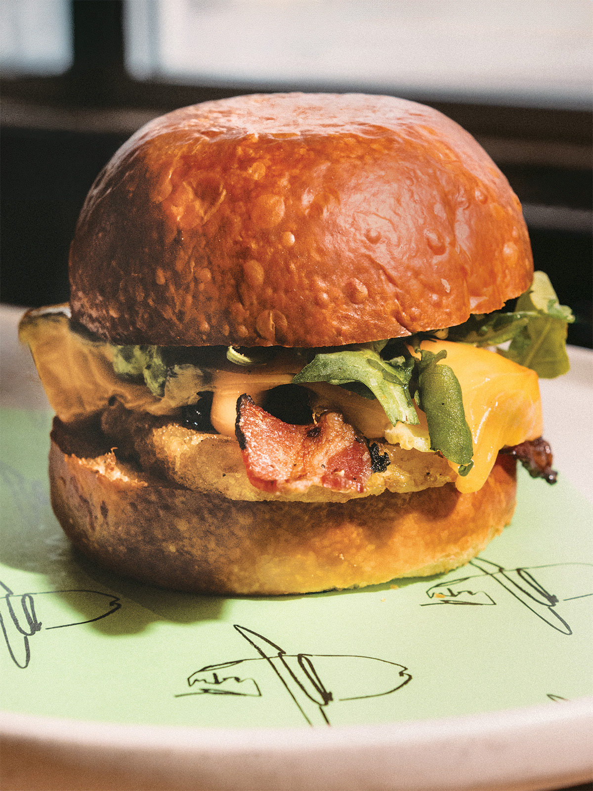 A breakfast sandwich with bacon and cheese