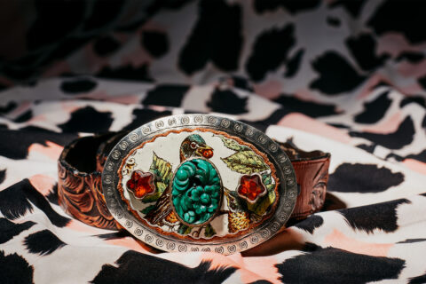 A turquoise-studded belt buckle from Sweet Bird Studio