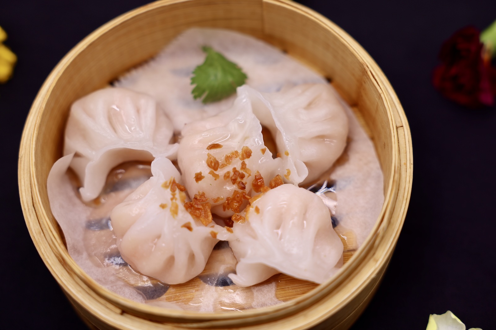 Shrimp har gao dumplings in a steamer basket.