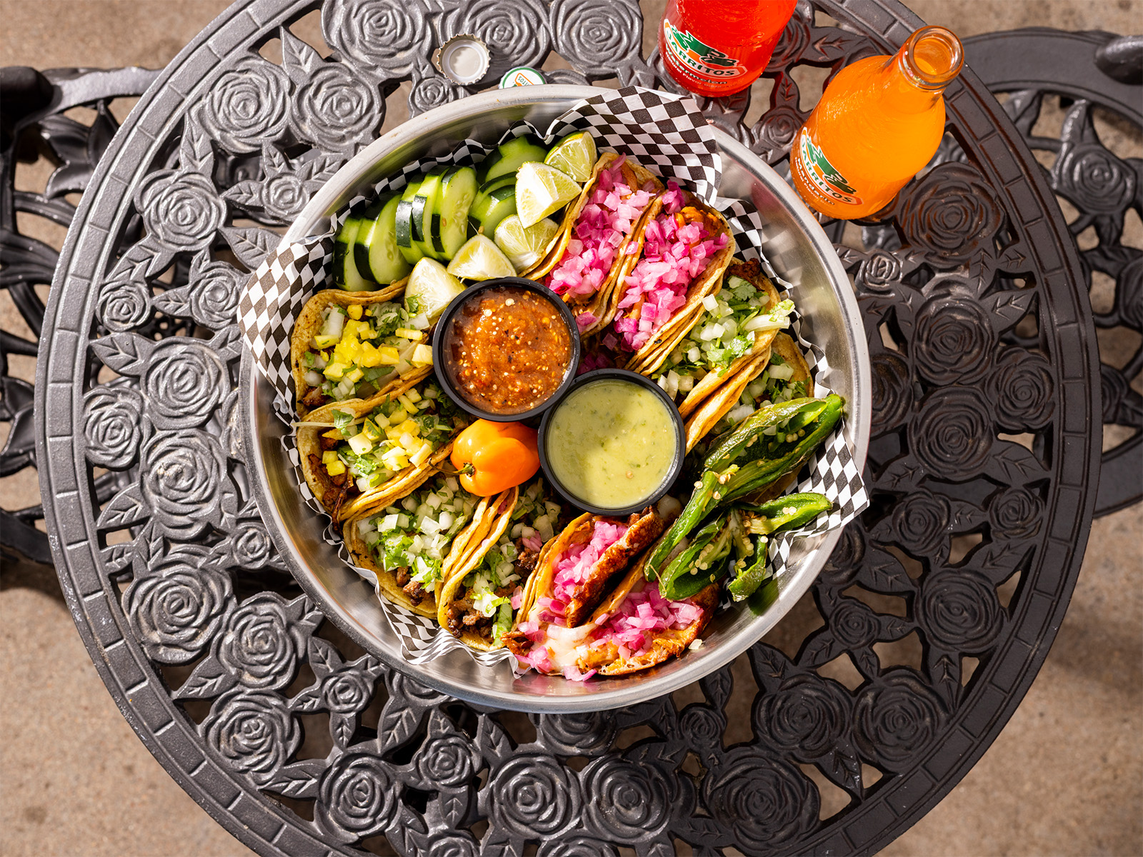 A plate of colorful tacos and salsas