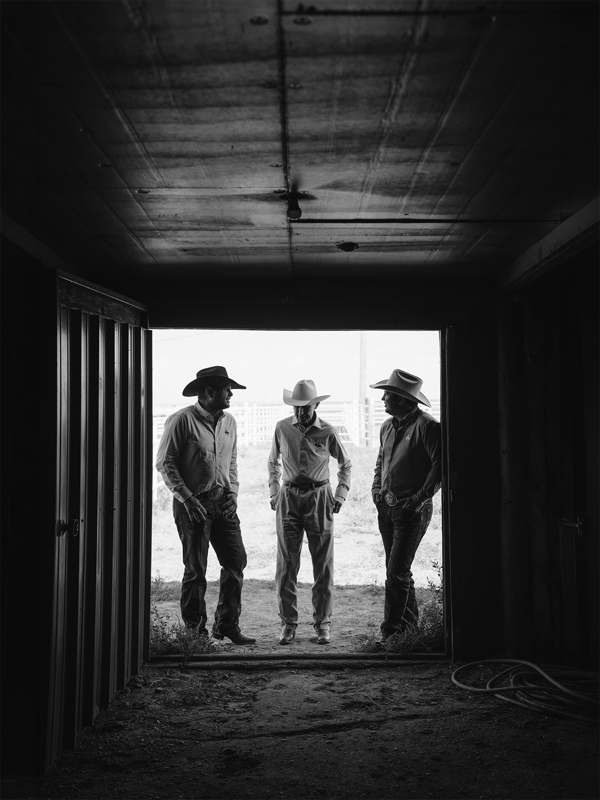 Three cowboys in a doorframe 