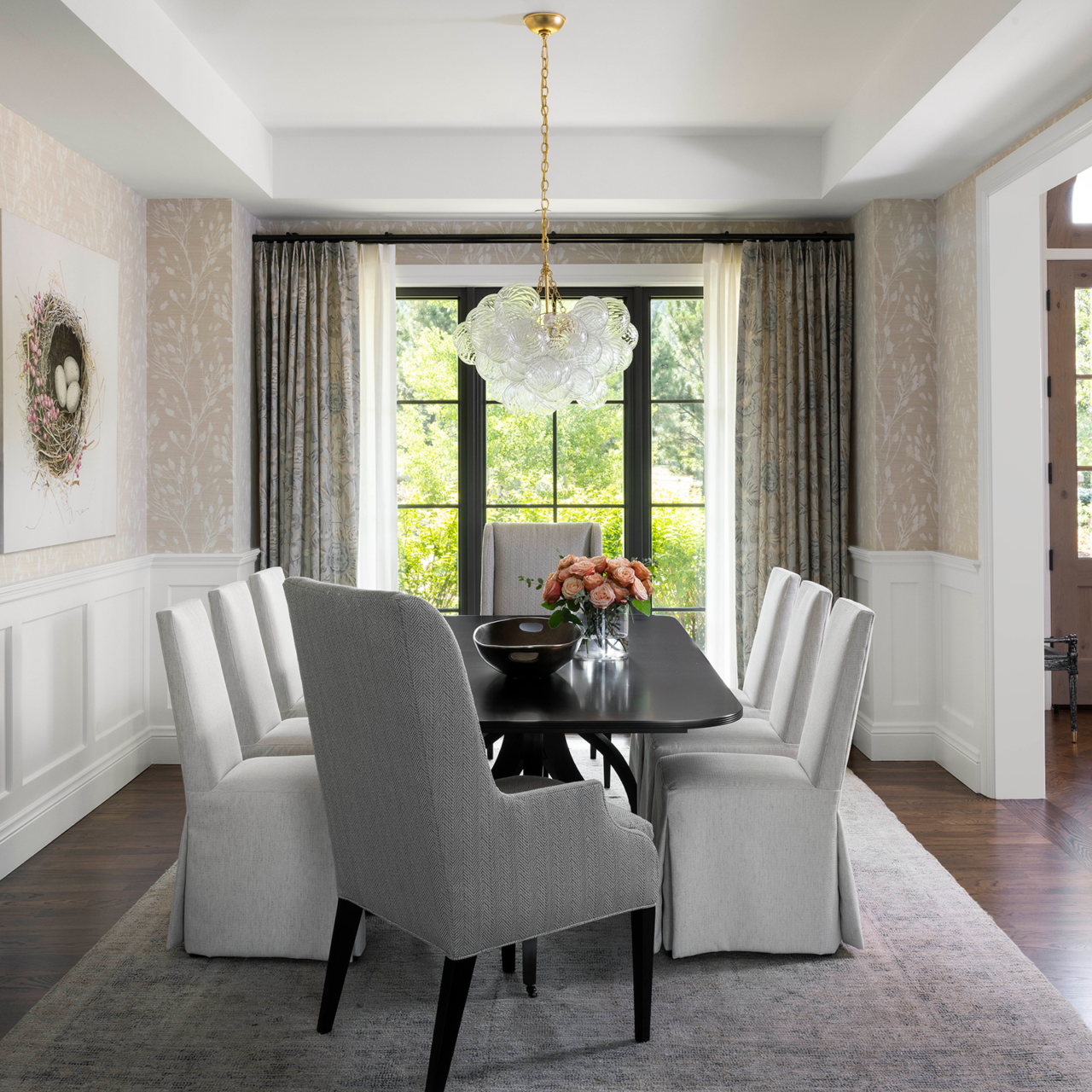 White dining room with floor-to-ceiling windows and white chairs