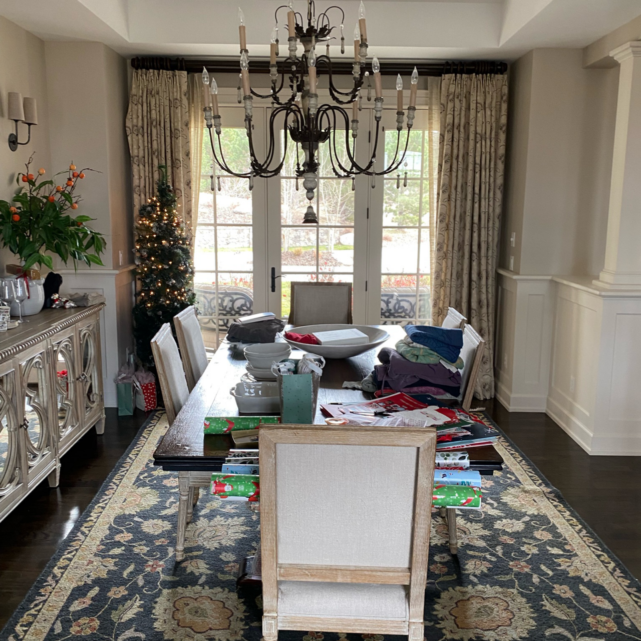 Outdated dining room with an exterior door and a patterened rug