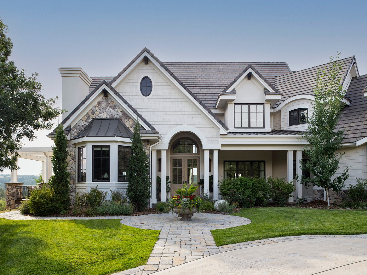 The white and stone facade of a large two-story home