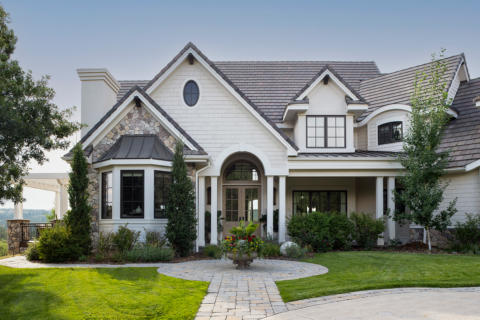 The white and stone facade of a large two-story home