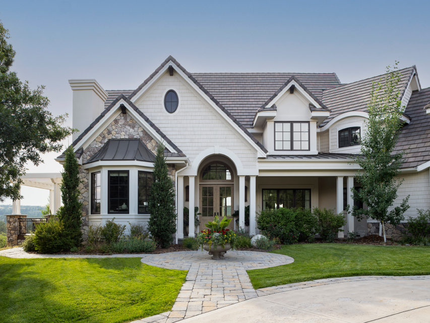 The white and stone facade of a large two-story home
