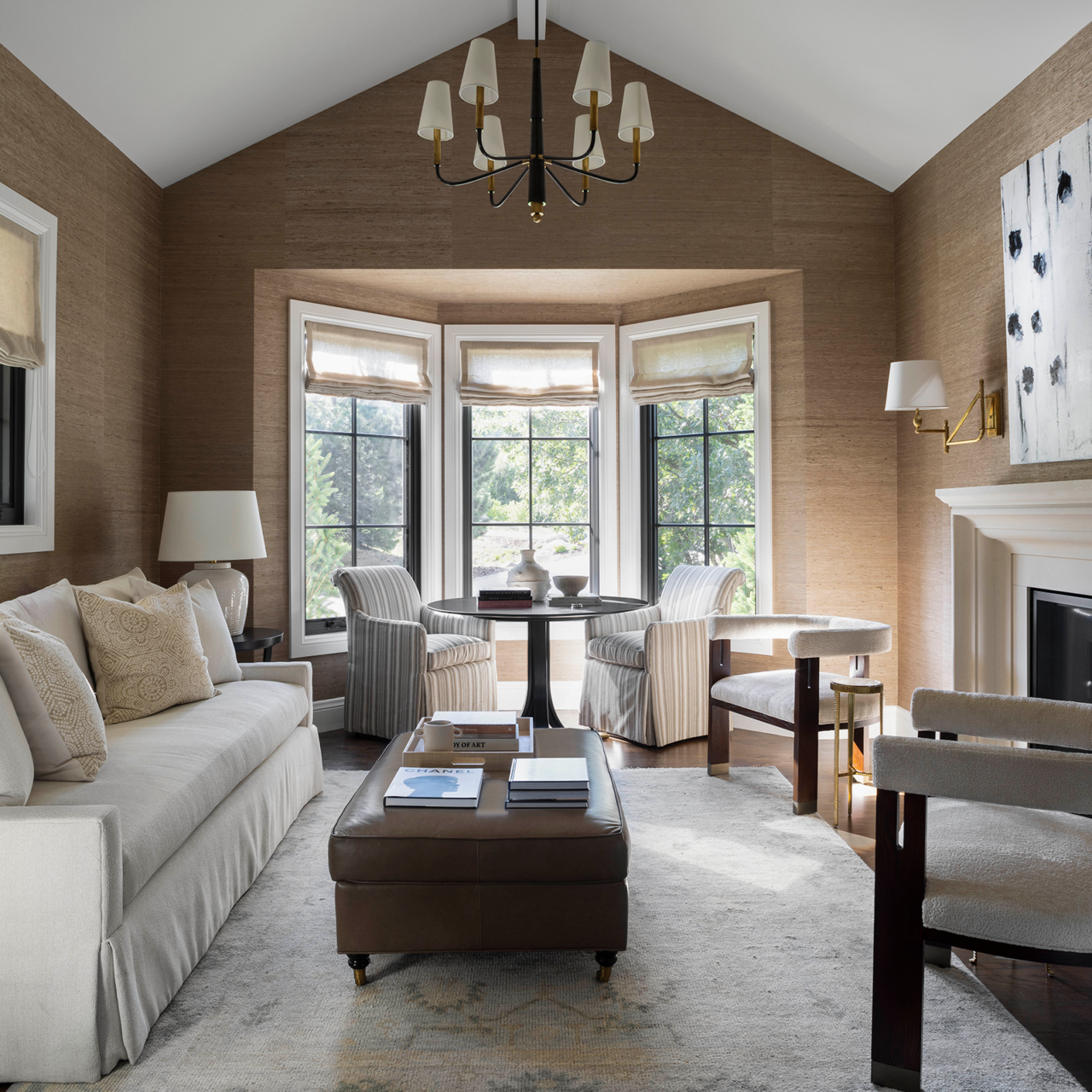 Beige study with chandelier and cream furniture