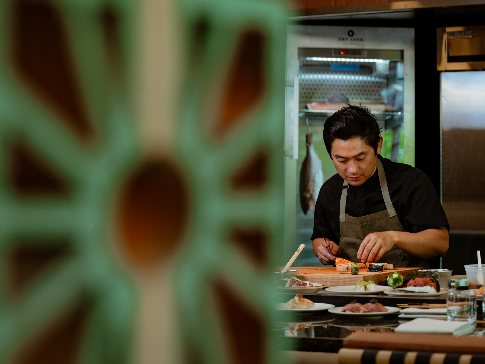 Chef Steven Lee plates a sushi dish