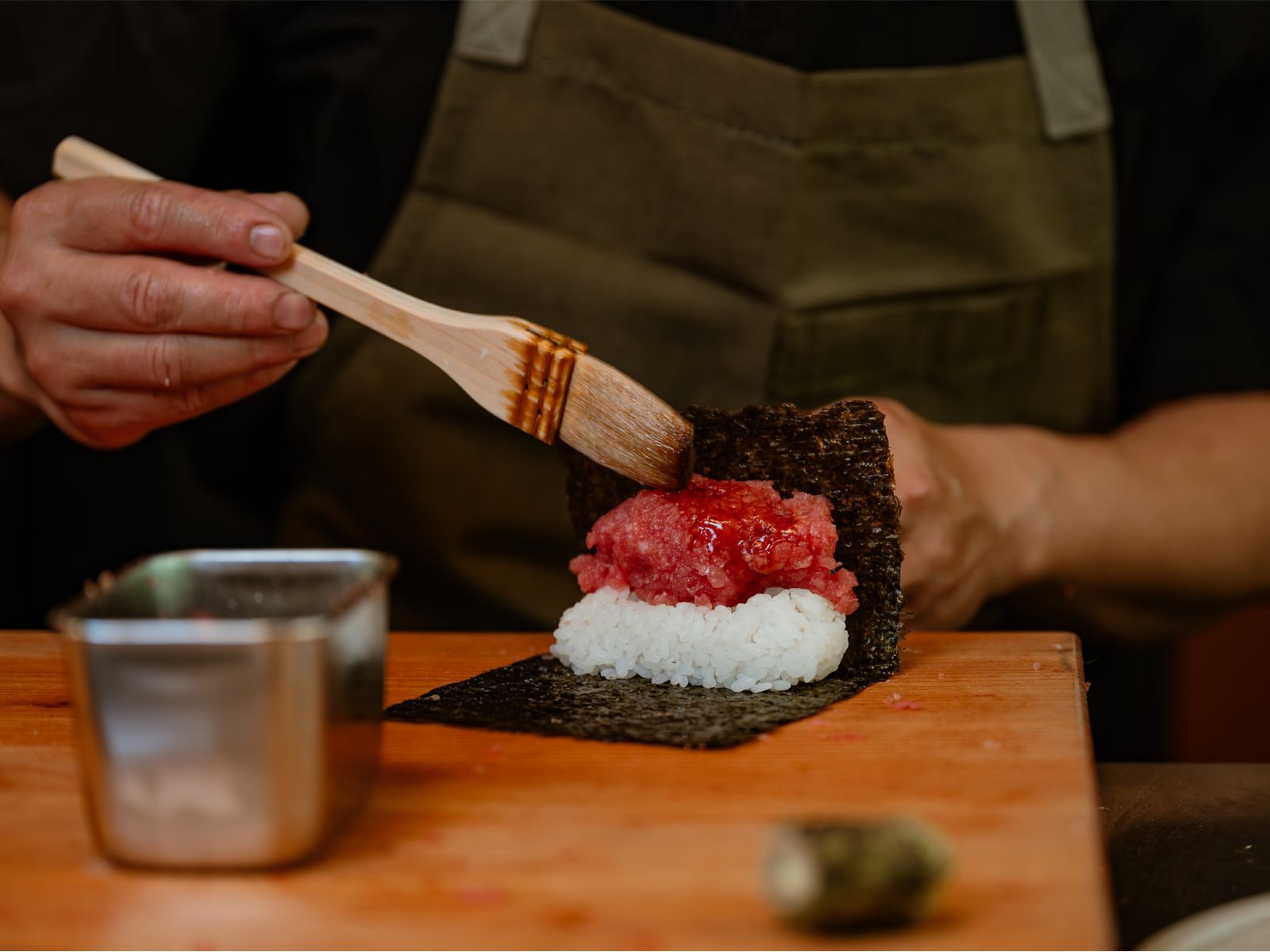 Chef Steven Lee packs a handroll at the sushi counter.
