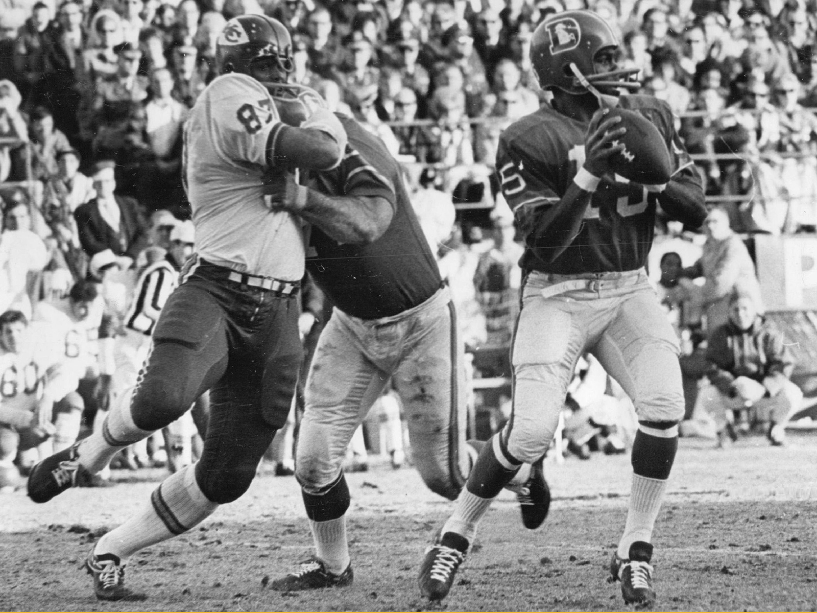 Marlin Briscoe of the Denver Broncos drops back to pass in a black-and-white photo