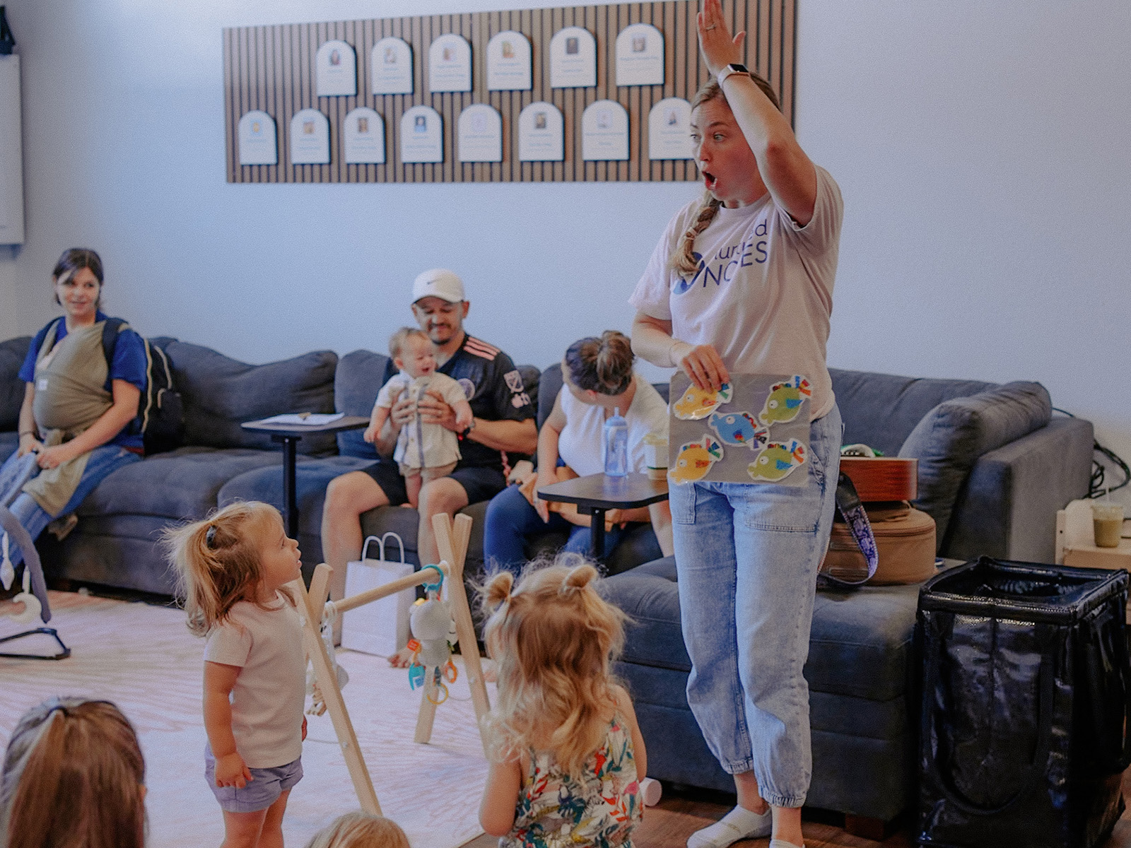 A staff member leads the children in song at Baby University’s grand opening