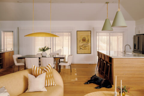 Open-concept living room, kitchen room, and dining room with pendant light fixtures