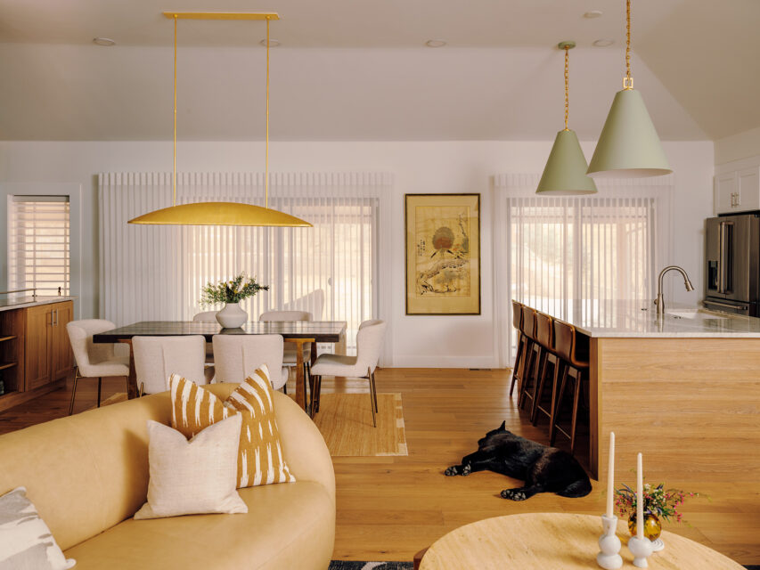 Open-concept living room, kitchen room, and dining room with pendant light fixtures