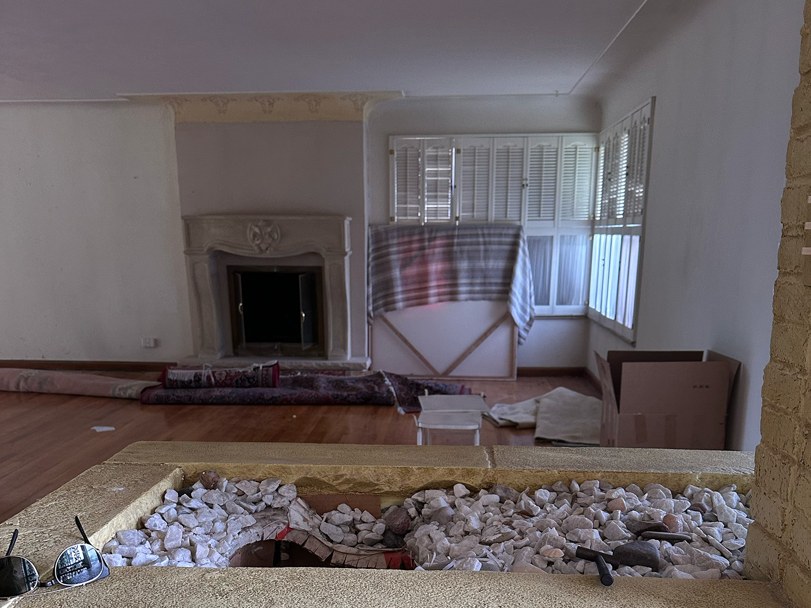 Empty living room with old fireplace