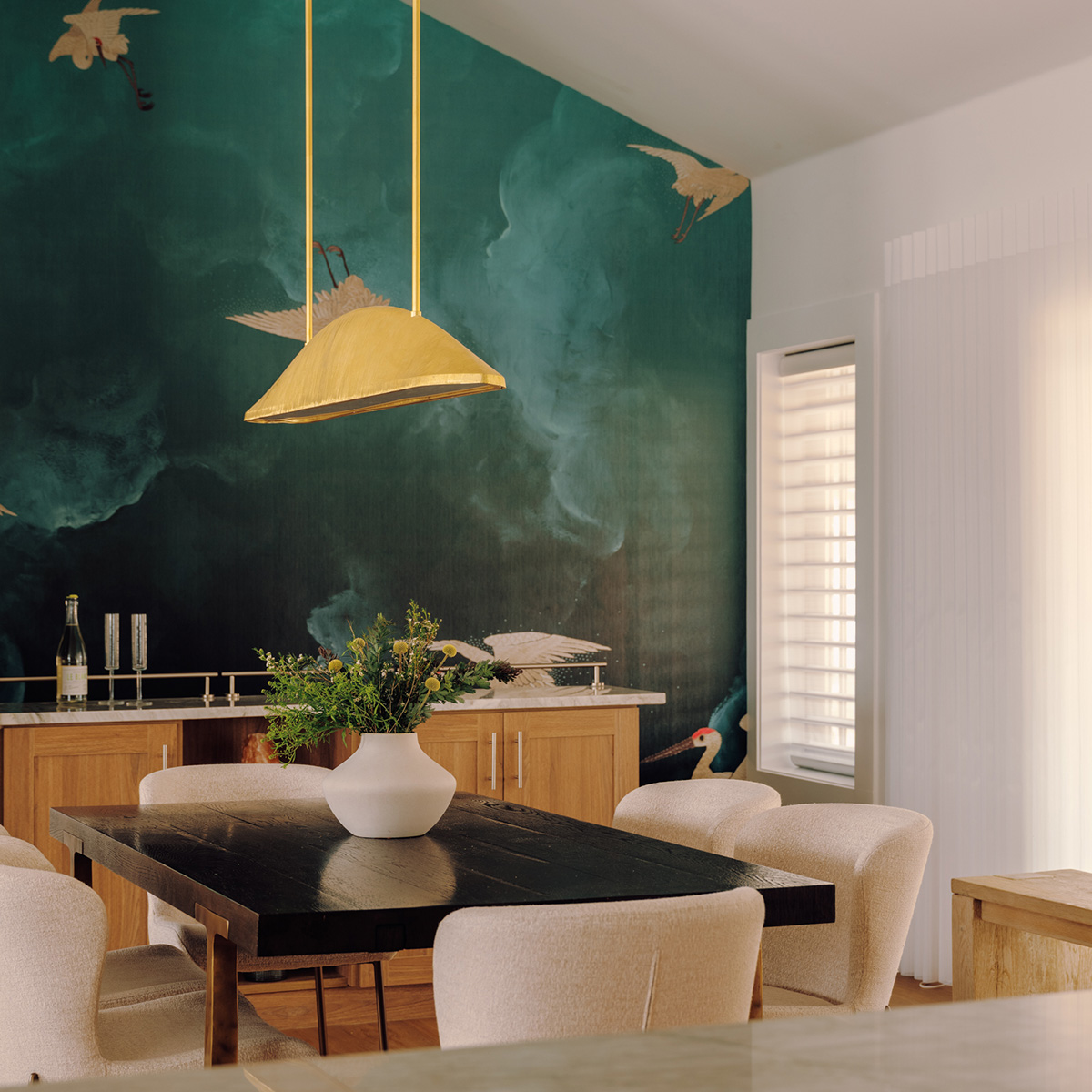 dining room with a crane mural on the wall