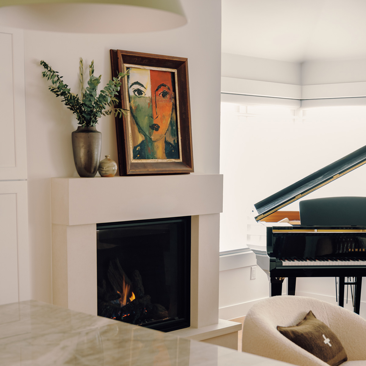 Modern white fireplace with a portrait on top