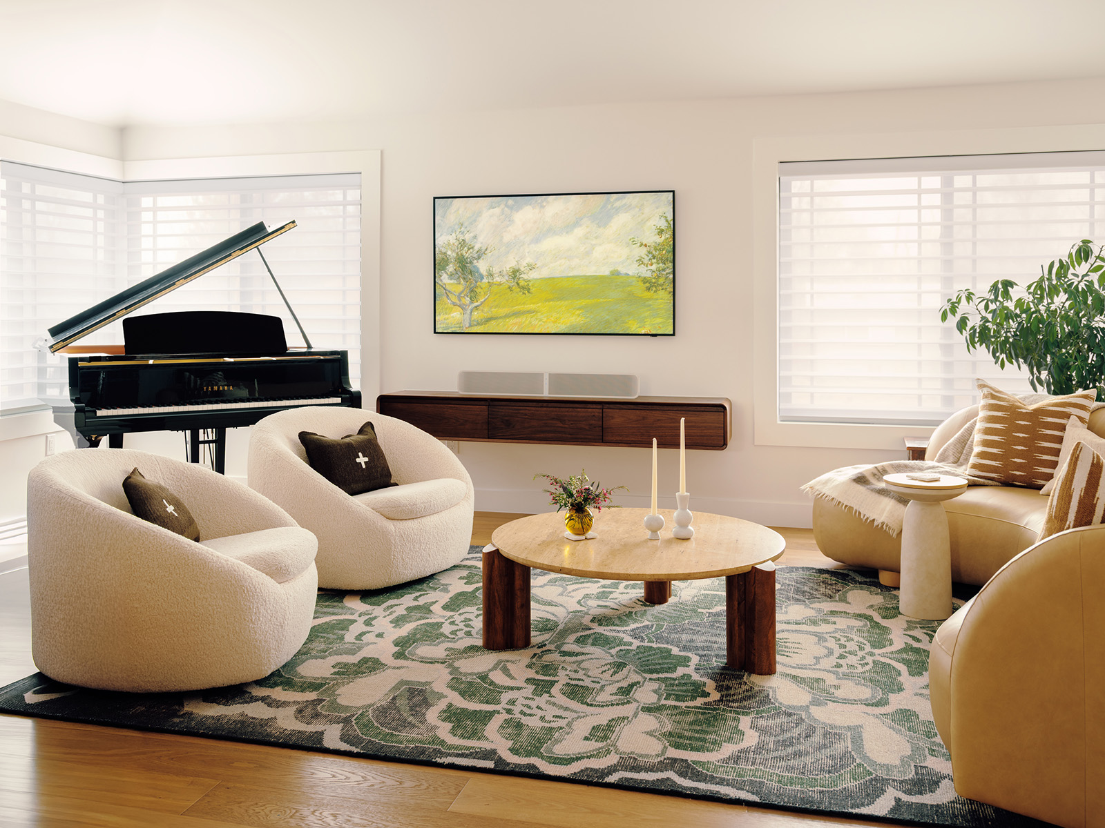 Living room with two white boucle chairs, a grand piano, and curved sofa