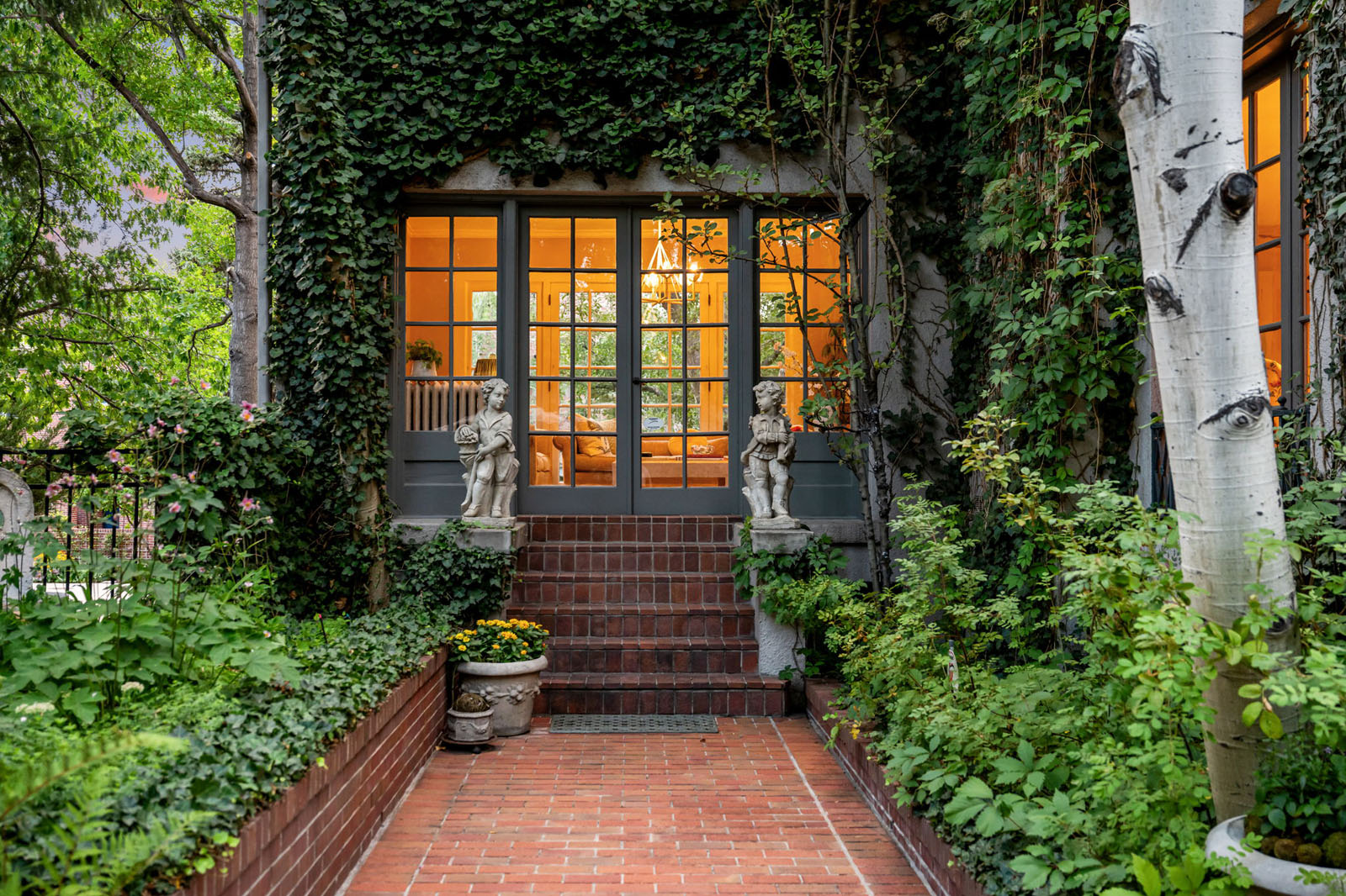 Exxterior of French doors covered in ivy