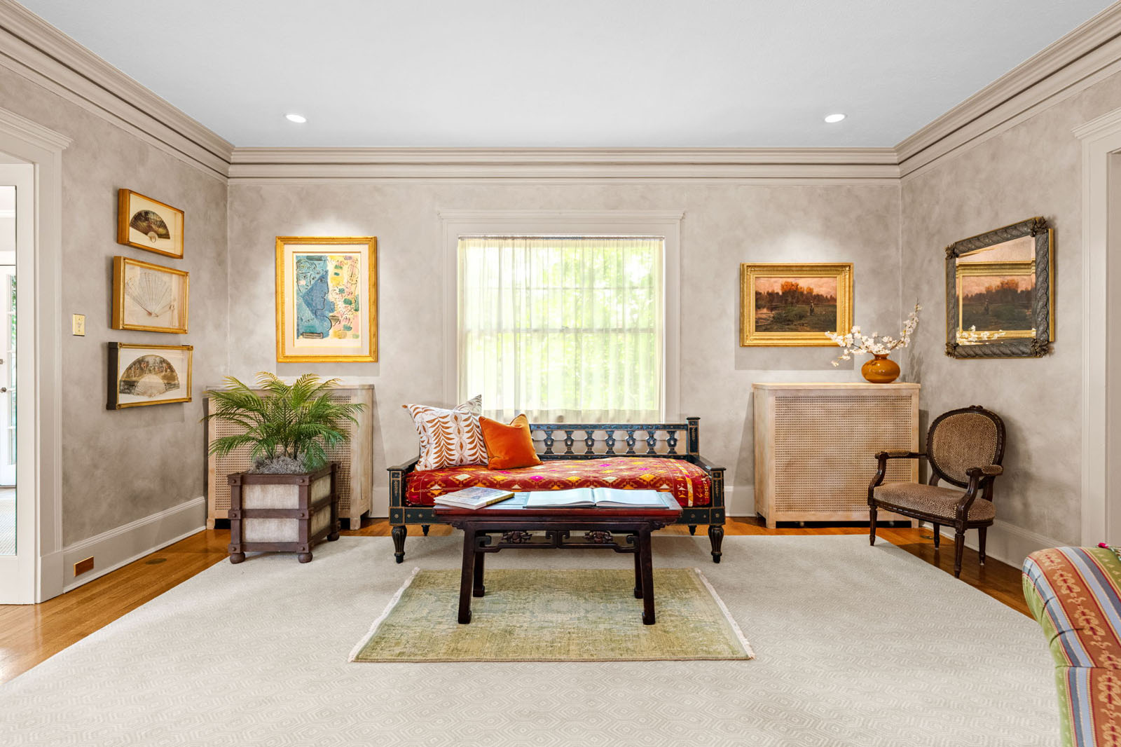 Sitting room with a art and a red couch