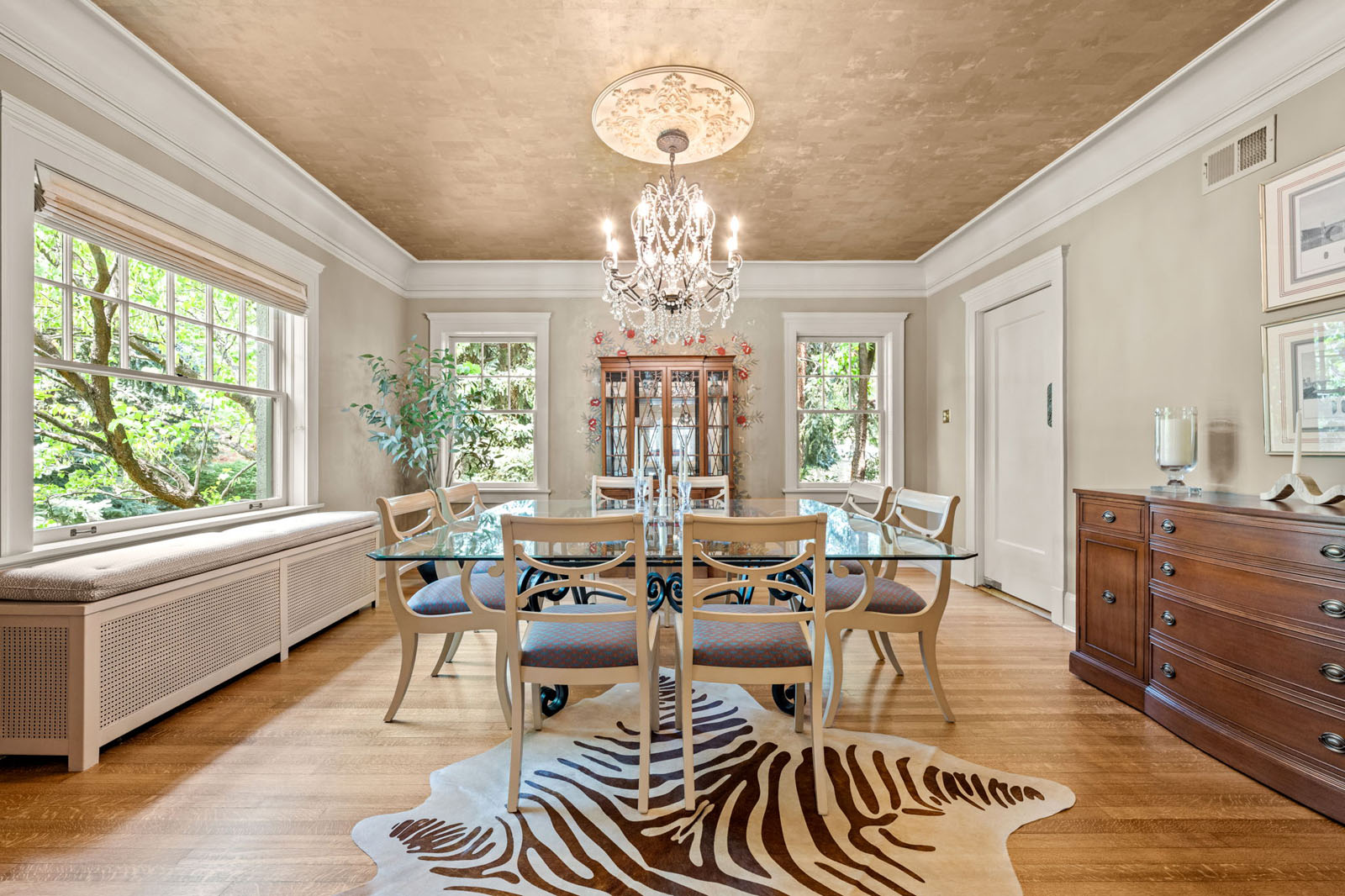 Formal dining room with zebra rug and a chandelier