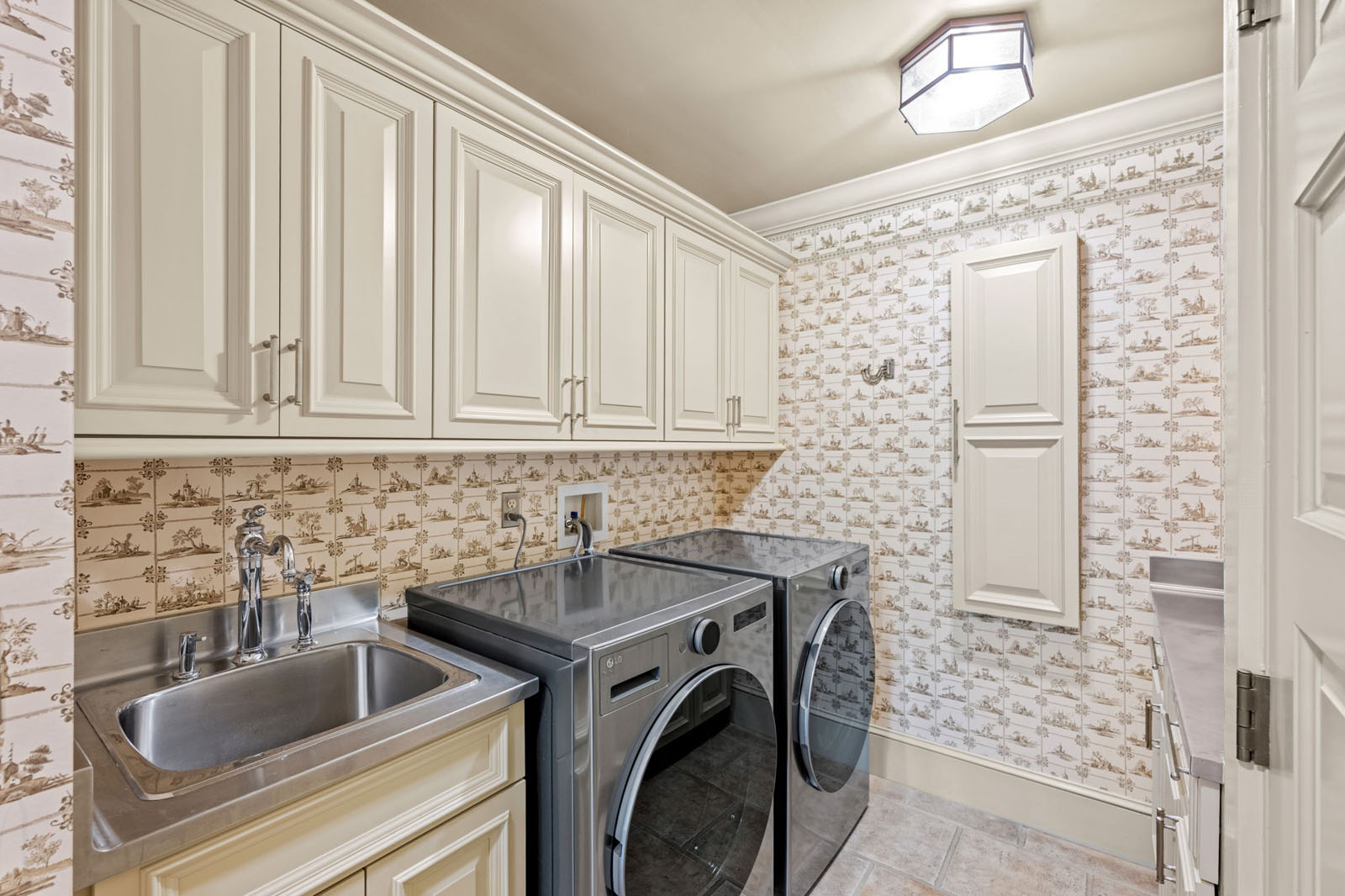 Laundry room with fun wallpaper