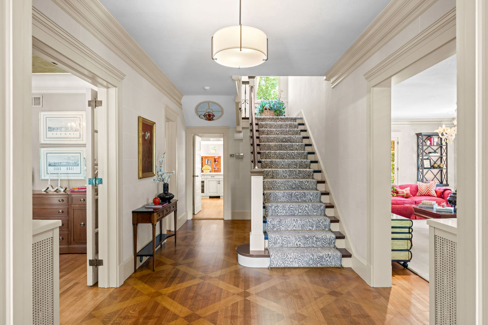 Entryway with stairwell covered in zebra stair runner
